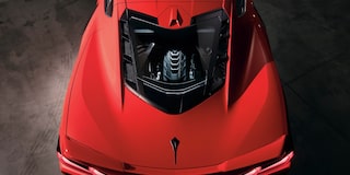 A Woman Lifted up the Front Hood of a 2025 Red Chevy Corvette Stingray
